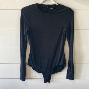 Black long sleeve body suit.